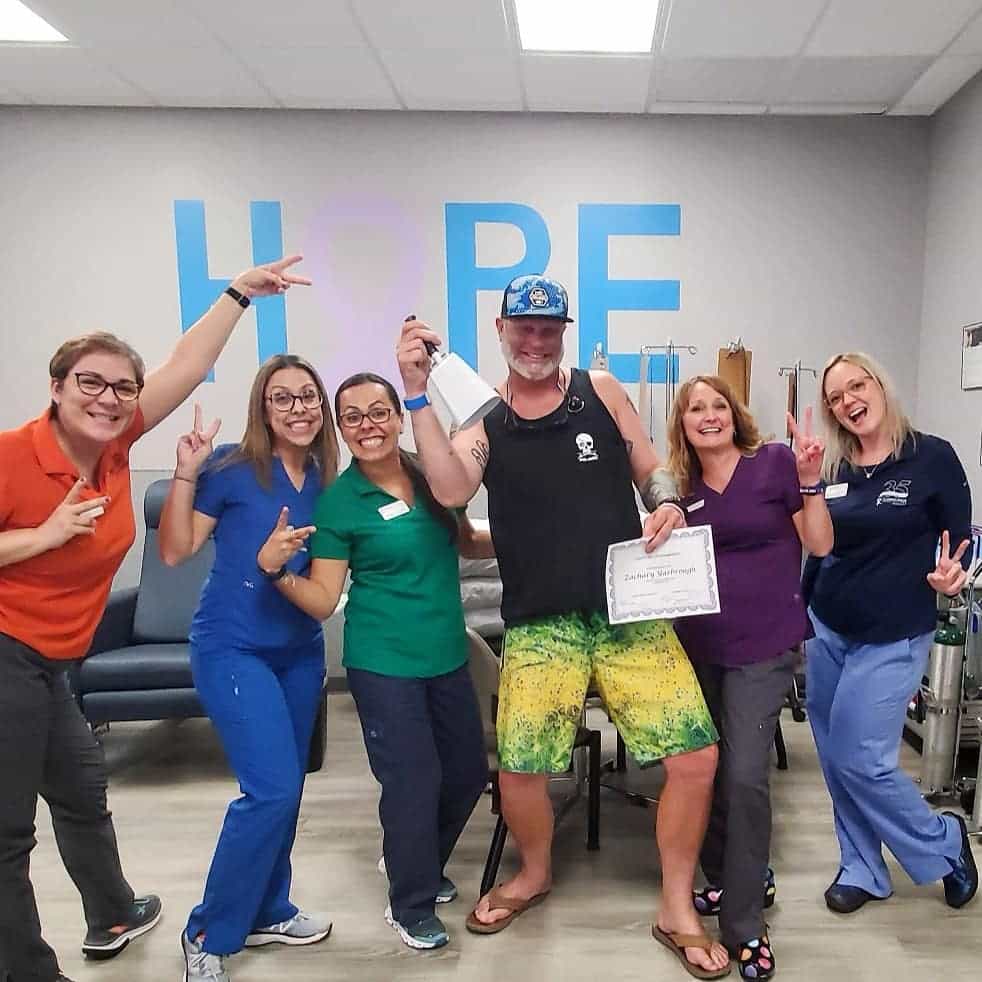 Our Warrior Wednesday spotlight, Zac Yarbrough, poses with hospital staff as he rings a white bell after one of his chemo treatments.